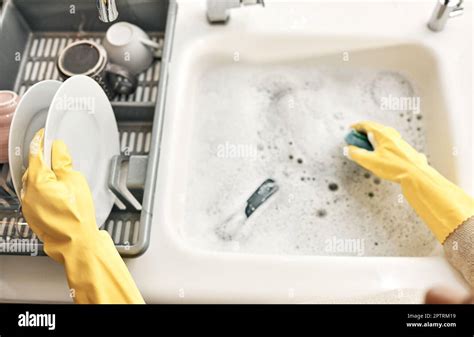 Housewife Maid Or Cleaner Hands Washing Dishes In The Kitchen Sink For