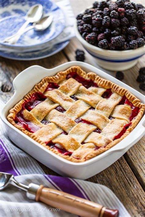 An Old Fashioned Blackberry Cobbler With A Lattice Top And A Bowl Of