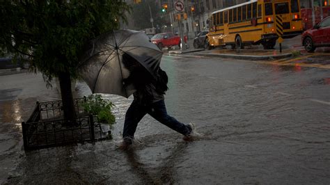 Commuters Navigate Flooding in New York City - The New York Times