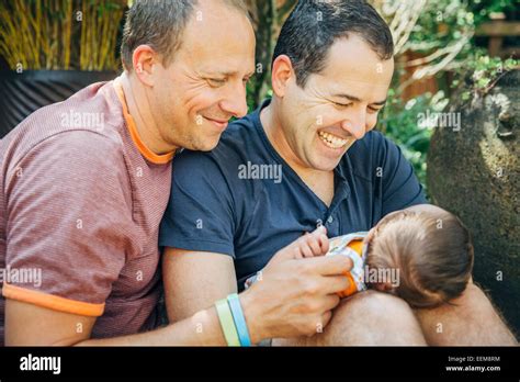 Caucasian Gay Couple Holding Baby Boy Outdoors Stock Photo Alamy