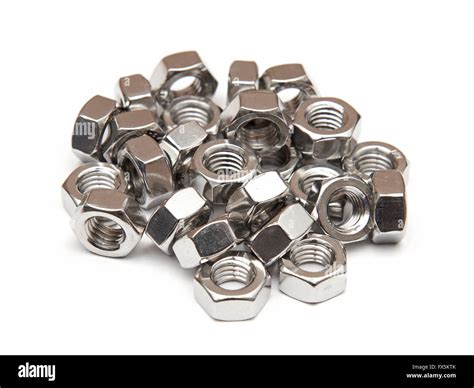 Closeup Of Galvanised Hexagon Nuts On A White Background Stock Photo