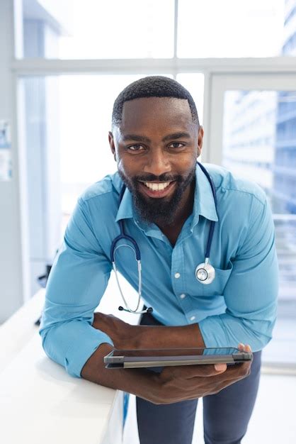 Premium Photo Portrait Of Happy African American Male Doctor Holding