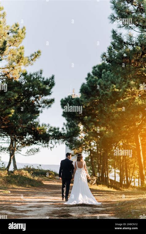 Just Married Couple Walking On A Forest At Sunset Stock Photo Alamy