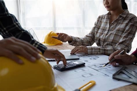 Engineer Team Working In Office With Blueprints Inspection In