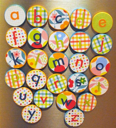 a bunch of magnets that are sitting on a refrigerator door with letters