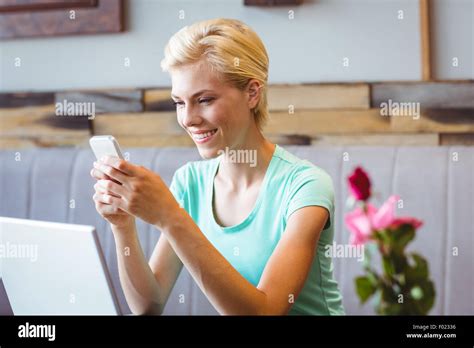 Pretty Blonde Woman Using Her Smartphone Stock Photo Alamy