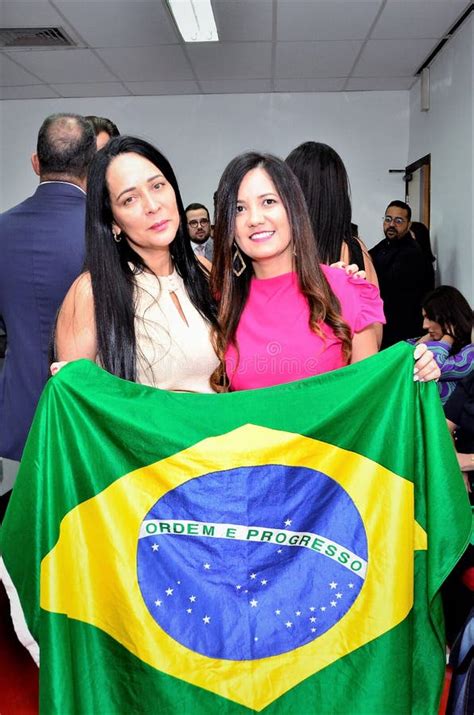 Cristiane Freitas Holds With Juciane Cunha The Brazilian Flag At The