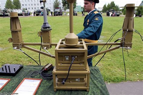 A Man In Uniform Standing Next To An Electronic Device On Top Of A