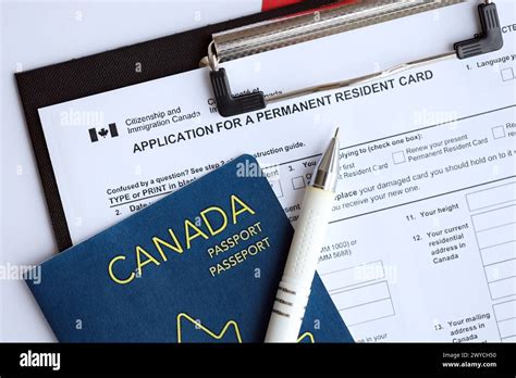 Application For Permanent Resident Card On Table With Pen And Canadian