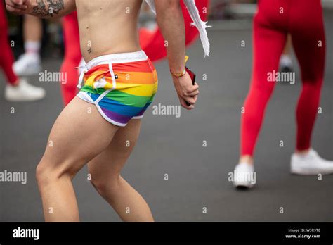 A Man Wearing Gay Pride Flag Shorts Dancing In The Street At A Pride Event Stock Photo Alamy