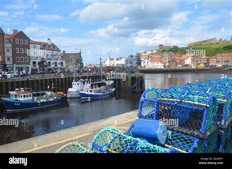 Fishing Boats In The Harbour Of The Historic Seaside Town Of Whitby