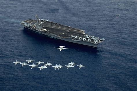 Aircraft of Carrier Air Wing 17 fly in formation above the aircraft ...