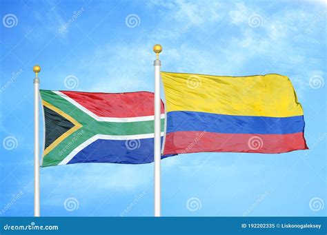 South Africa And Colombia Two Flags On Flagpoles And Blue Sky Stock