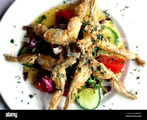 Plate of frogs legs on French restaurant table in London 2007 Stock ...