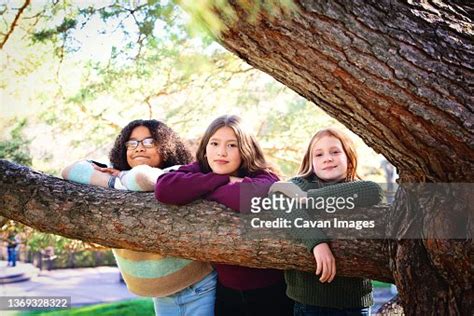 Three Pretty Tween Girls Laughing Together Outdoors In Fall Colors High