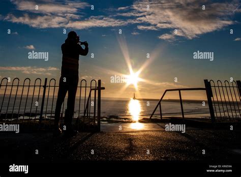 Sunderland, UK. 19th Dec, 2017. UK Weather: A man captures the sunrise ...