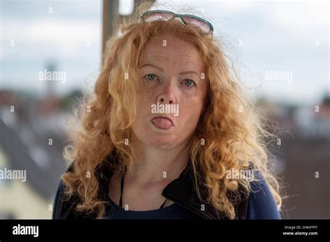 Beauty Sassy Naughty Mature Redhead Woman With Curly Red Blond Hair Sticks Out Her Tongue Copy