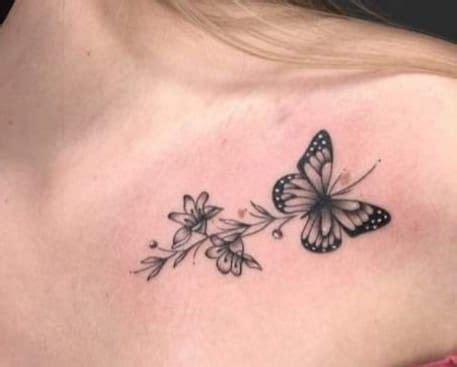 A Woman With A Butterfly Tattoo On Her Shoulder