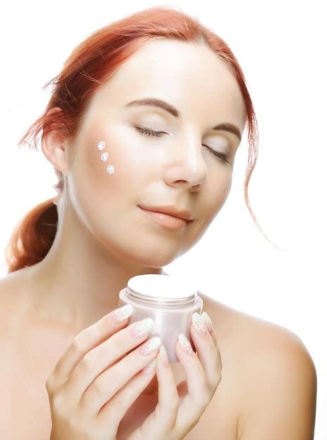 Premium Photo Smiling Woman Applying Cream On Her Face