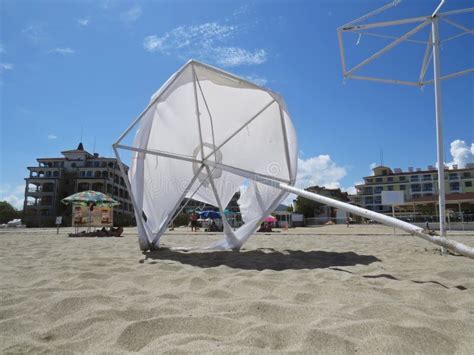 Laying Destroyed White Sand Beach Parasol Umbrella In Wind Protecting