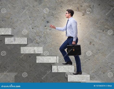 Businessman Climbing Career Ladder In Business Concept Stock Photo