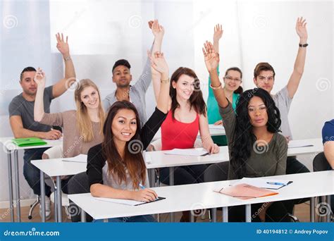 College Students Raising Hands In Classroom Stock Photo Image 40194812