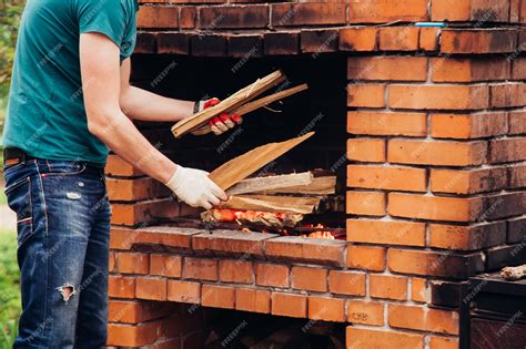 Premium Photo A Man Prepares Steaks On A Barbecue Grill Outdoors