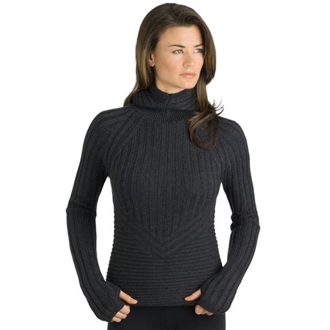 A Woman Wearing A Turtle Neck Sweater And Leggings With Her Hands On