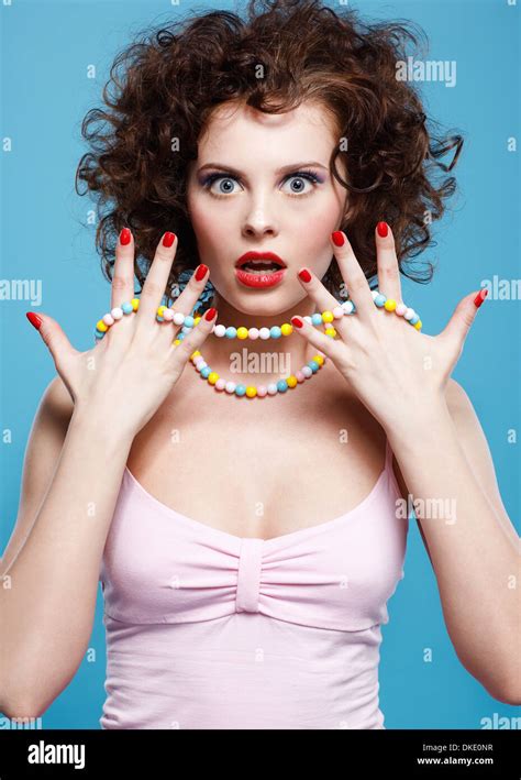 Portrait Of Beautiful Curly Brunette Girl On Blue Stock Photo Alamy