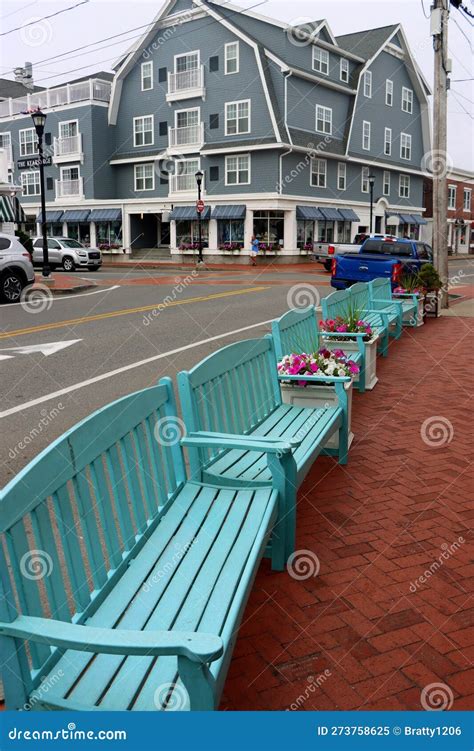 Welcoming Shops Restaurants And Blue Benches Line The Sidewalks Of