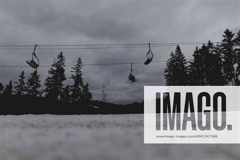 Skiers Ride A Chairlift Taken On A Ski Slope In The Jizera Mountains