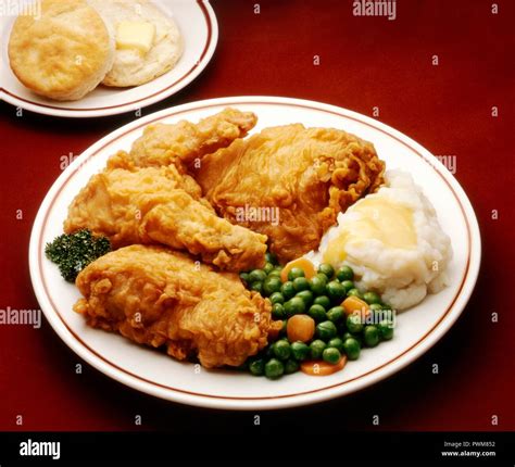 Fried Chicken Dinner Plate Fried Chicken Mashed Potato Peas And Carrots And A Biscuit Stock