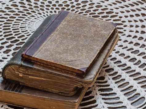 Three Old Books Lying On Top Of Each Other On The Table Stock Image