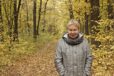 A Man Of Mature Age In The Forest By The Road Put His Hand On The Body Of The Car Stock Image