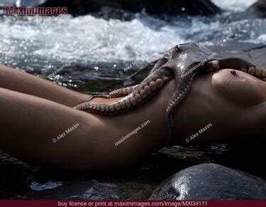 Nude Woman Lying In Water With Octopus Tentacles Wrapped Around Her