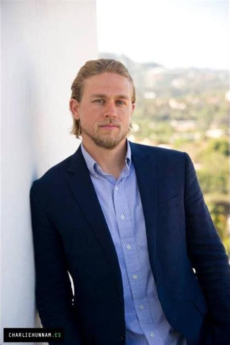 A Stylish Man Leaning Against A Wall