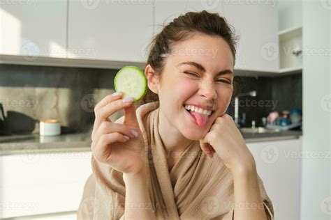 Portrait Of Beautiful Brunette Girl Cooking In The Kitchen Posing In Bathrobe At Home Holding