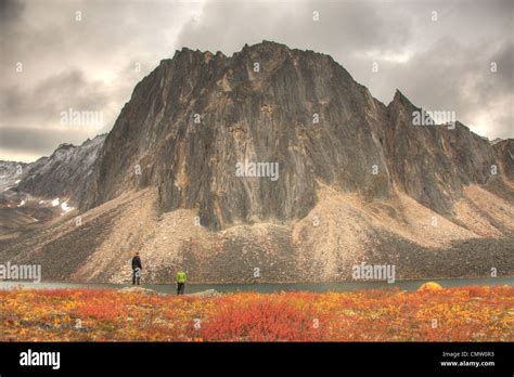 Hikers Around Talus Lake In Autumn Tombstone Territorial Park Along