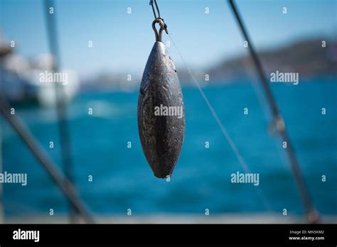 Lead weight or sinker used for fishing Stock Photo - Alamy