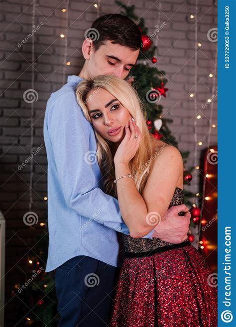 A Girl In A Beautiful Dress Hugs And Kisses A Guy New Yearand X27 S