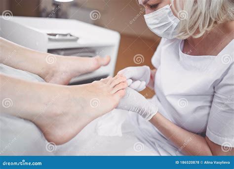 Pedicurist Doing Professional Medical Pedicure Procedure In Beauty