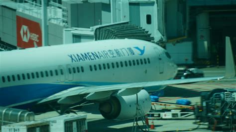 A xiamen airlines plane at an airport terminal. photo – Free Car Image