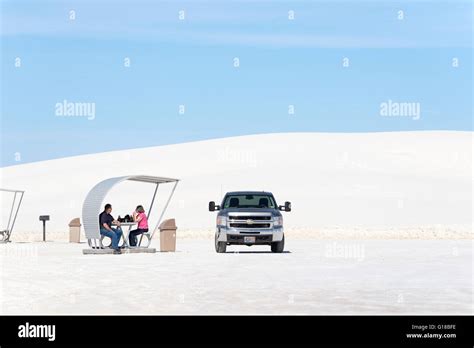 Couple Picknicking Under Shade Shelter In White Sands National Monument