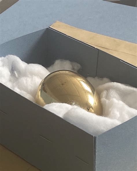 Brass Egg Sculpture That Looks