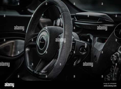 An interior view of a luxury black McLaren vehicle, with its sleek and ...