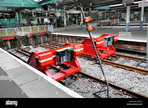 New red friction buffers on the rail tracks at Swansea train station in ...