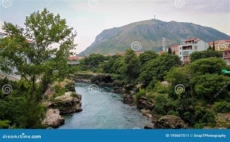 The Neretva River Flowing Through Mostar With Hum Hill And Christain