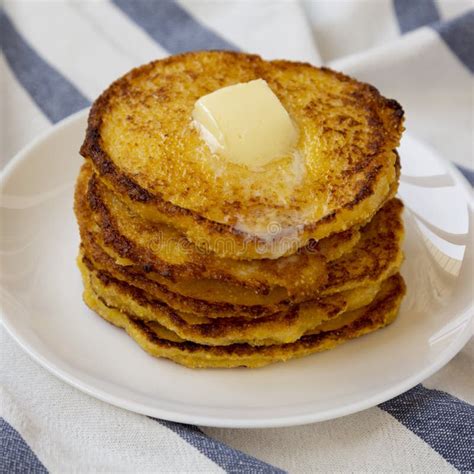 Homemade Corn Meal Johnny Cakes with Butter on a White Plate, Side View ...