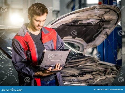 Mechanic Examining Car Engine With Help Of Laptop Editorial Stock Image