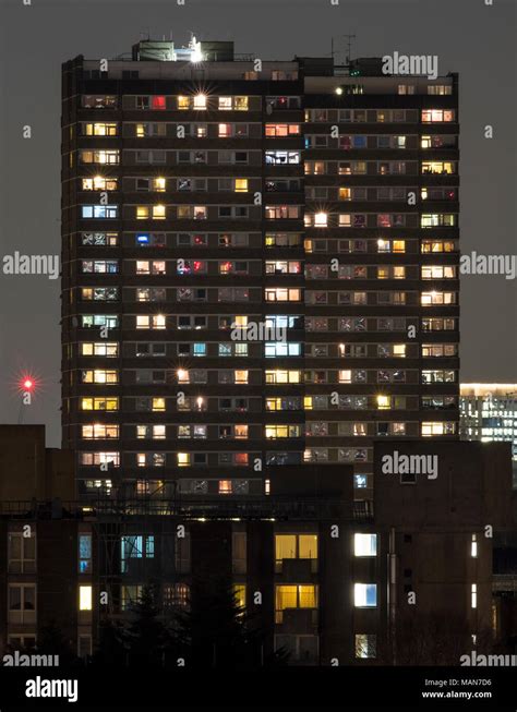 Towerblock At Night Showing The Variety Of Lives And Lights That Exist In A Single Apartment